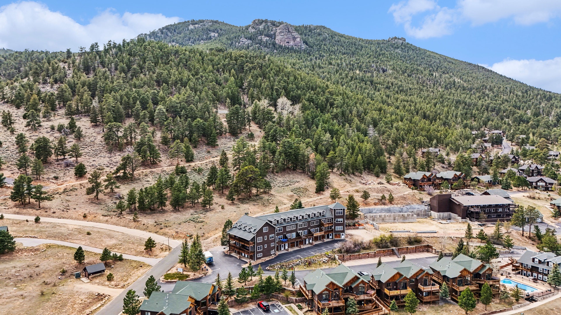 Mountain resort community nestled beneath forested peaks in a scenic alpine setting.