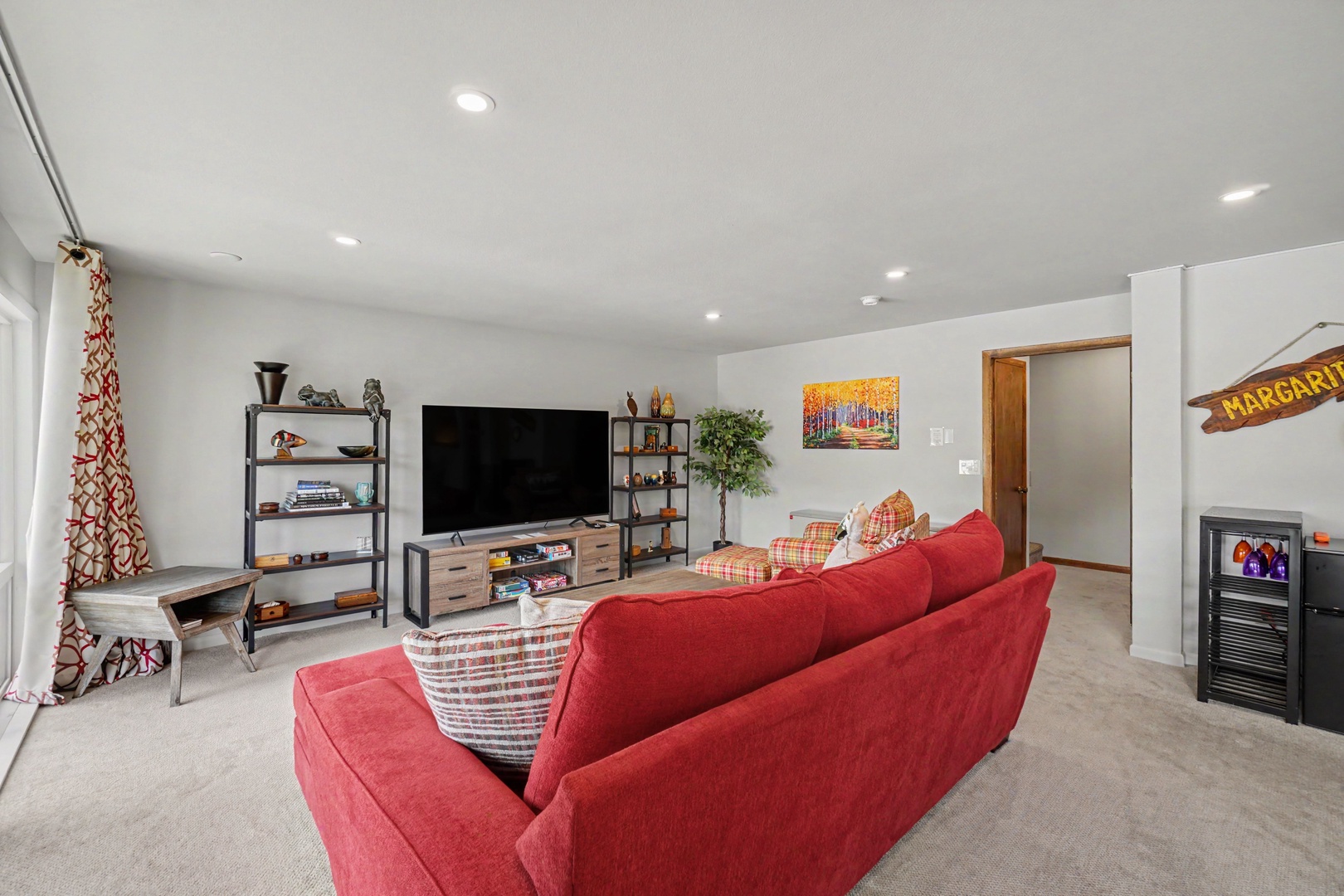 Relax and recharge in the inviting lower level, thoughtfully furnished with plush seating and Smart TV.