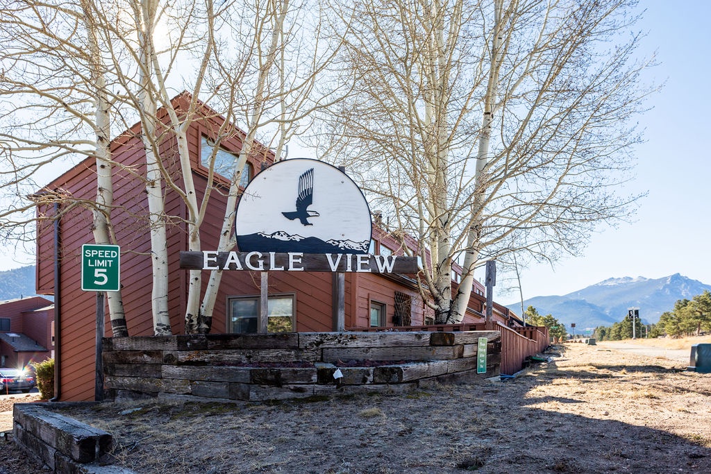 Eagle View property entrance with mountain backdrop and rustic charm welcomes guests to this scenic destination.