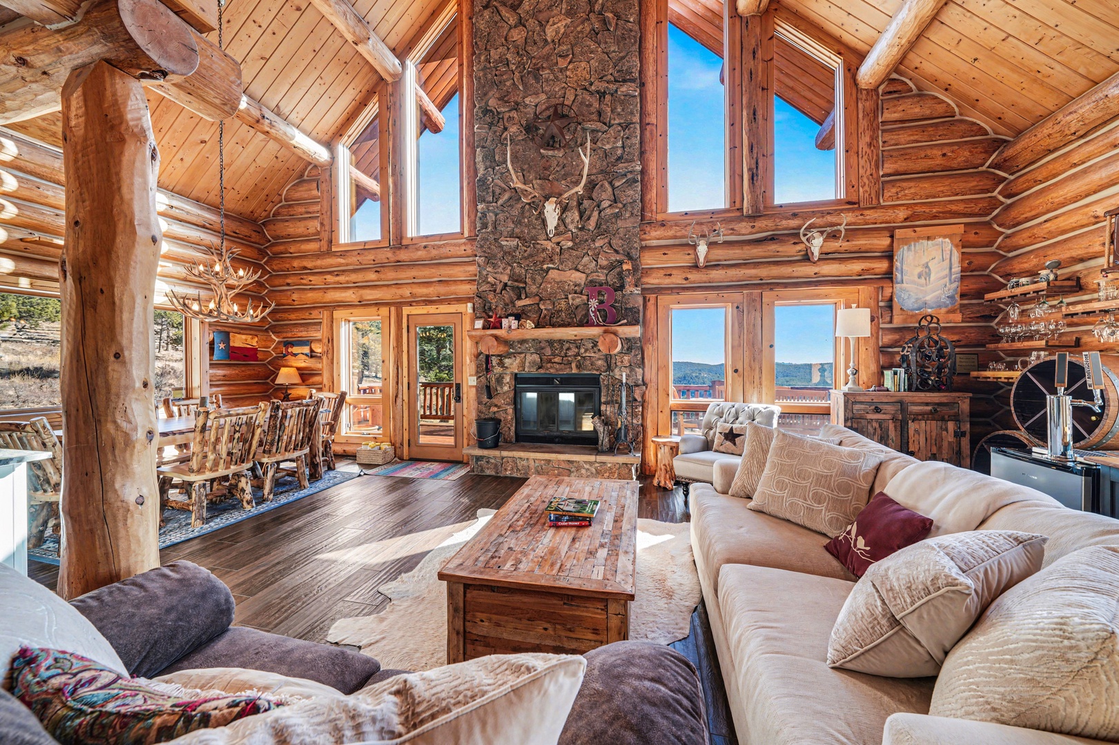 Cozy up in this stunning log cabin living room where rustic charm meets modern comfort, complete with soaring ceilings and warmth.