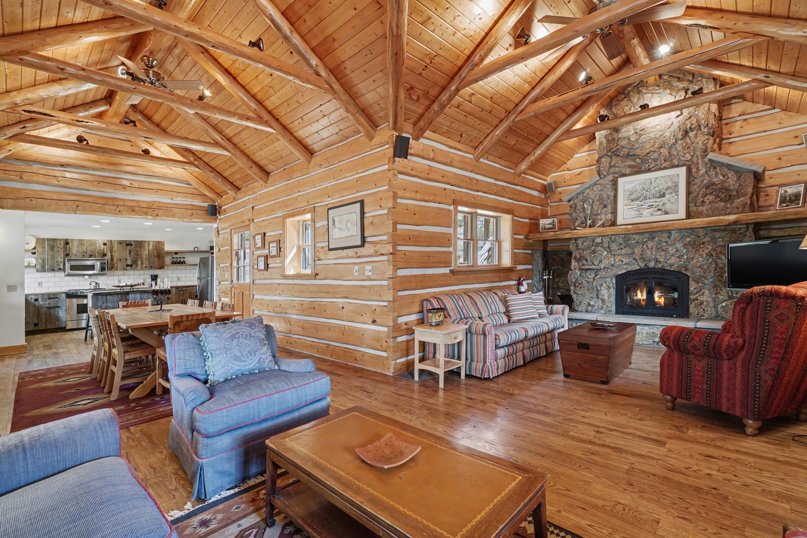 Gather around this cozy log cabin's stone fireplace while soaking in vaulted ceilings and rustic charm that makes your mountain retreat unforgettable.