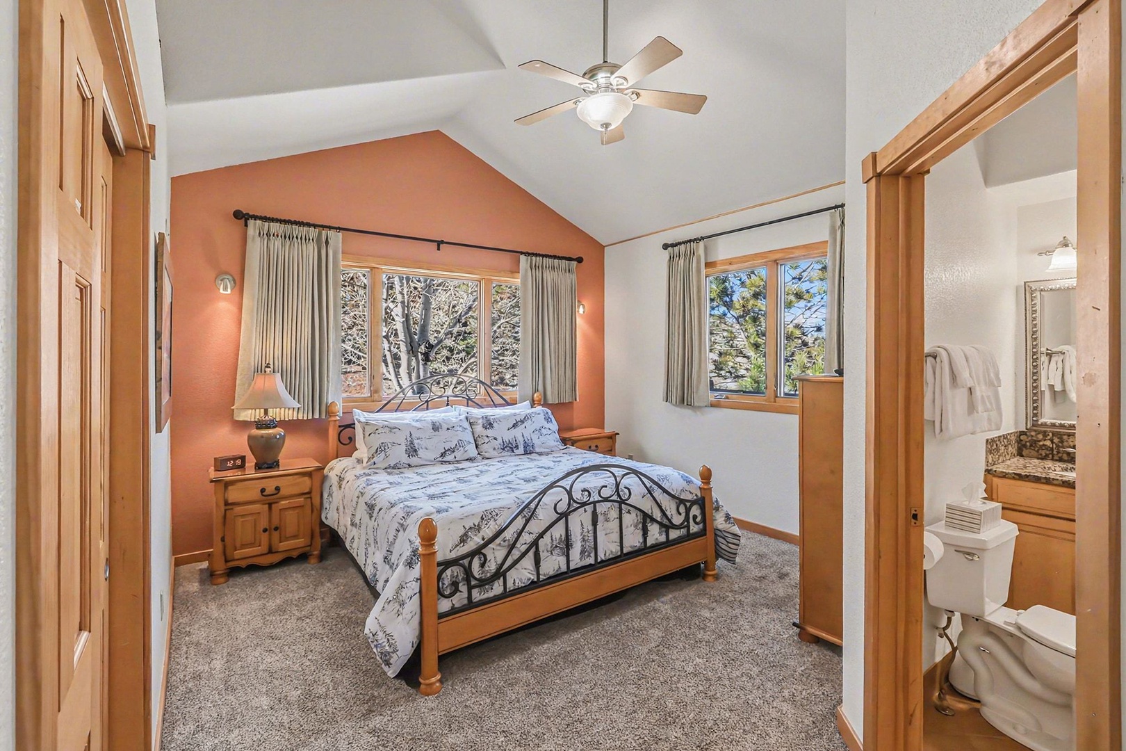 Drift off in your cozy king bedroom with vaulted ceilings and warm wood accents.