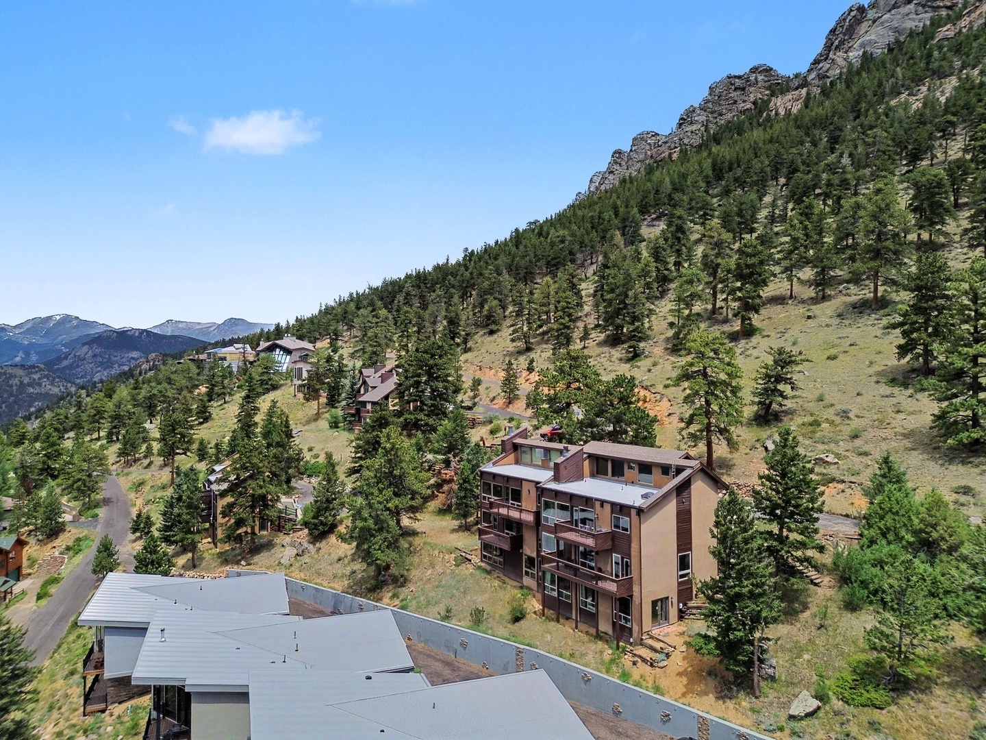 Aerial view of property with mountain backdrop.