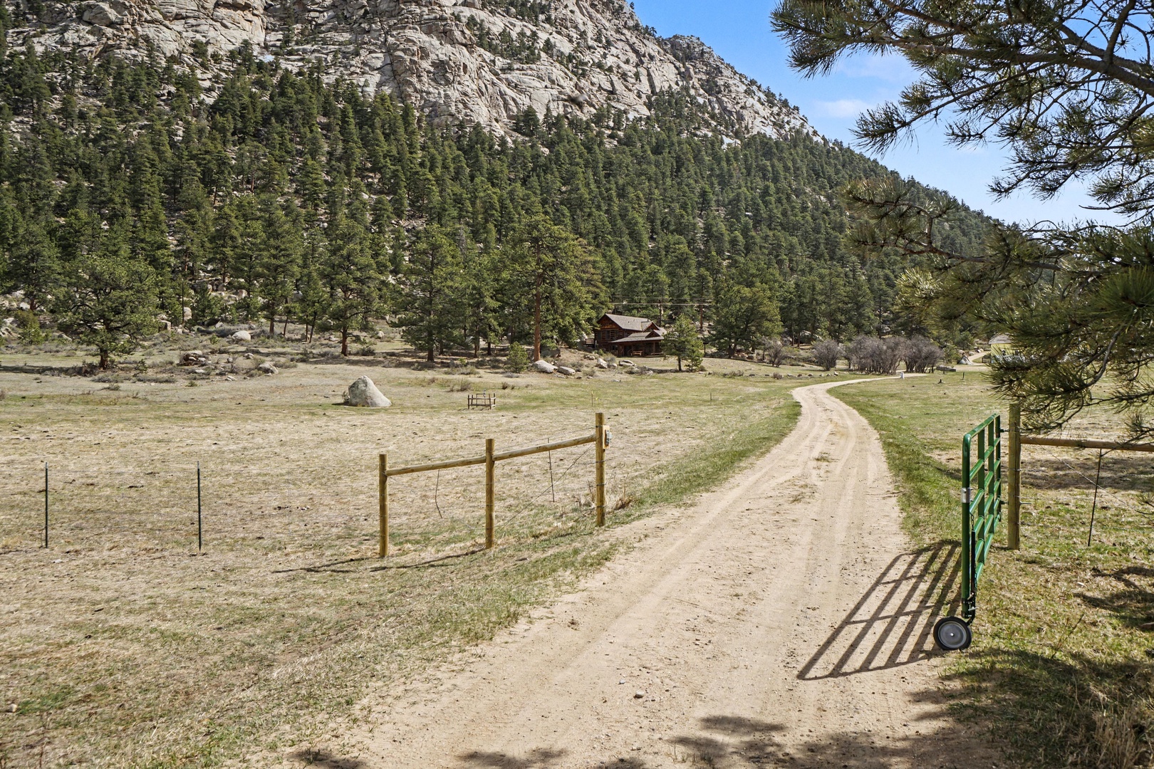 A serene mountain valley setting with forested hills and rustic charm defines this peaceful rural retreat.