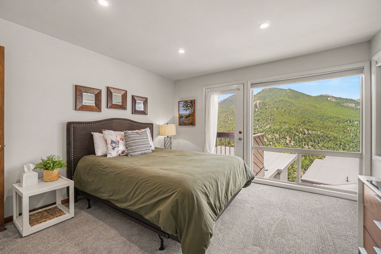 Wake up to breathtaking mountain views through floor-to-ceiling windows. This Queen sized bedroom has direct balcony access.