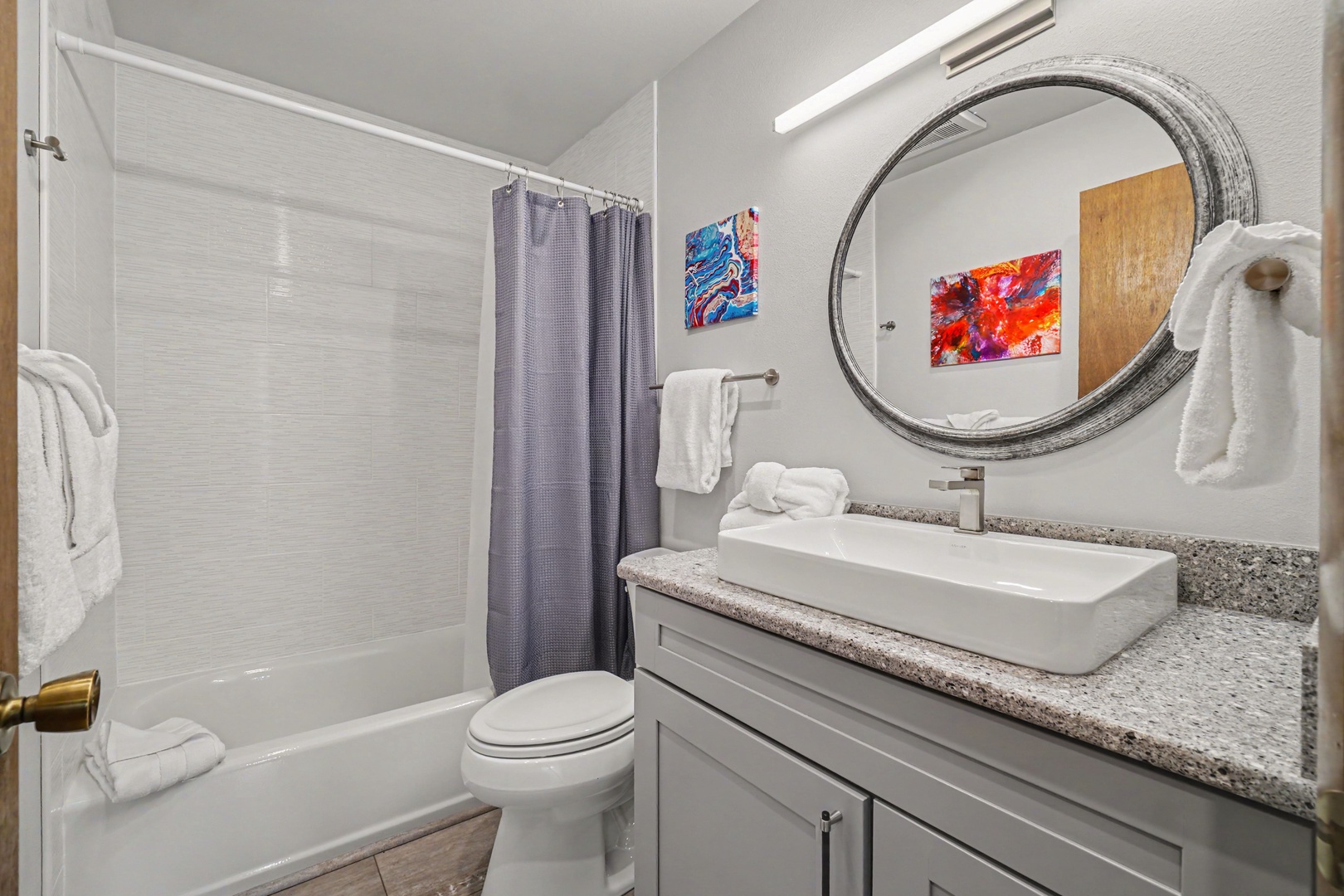 Step into your bright full hallway bathroom. Relax in the tub-shower combo after a day of exploring.