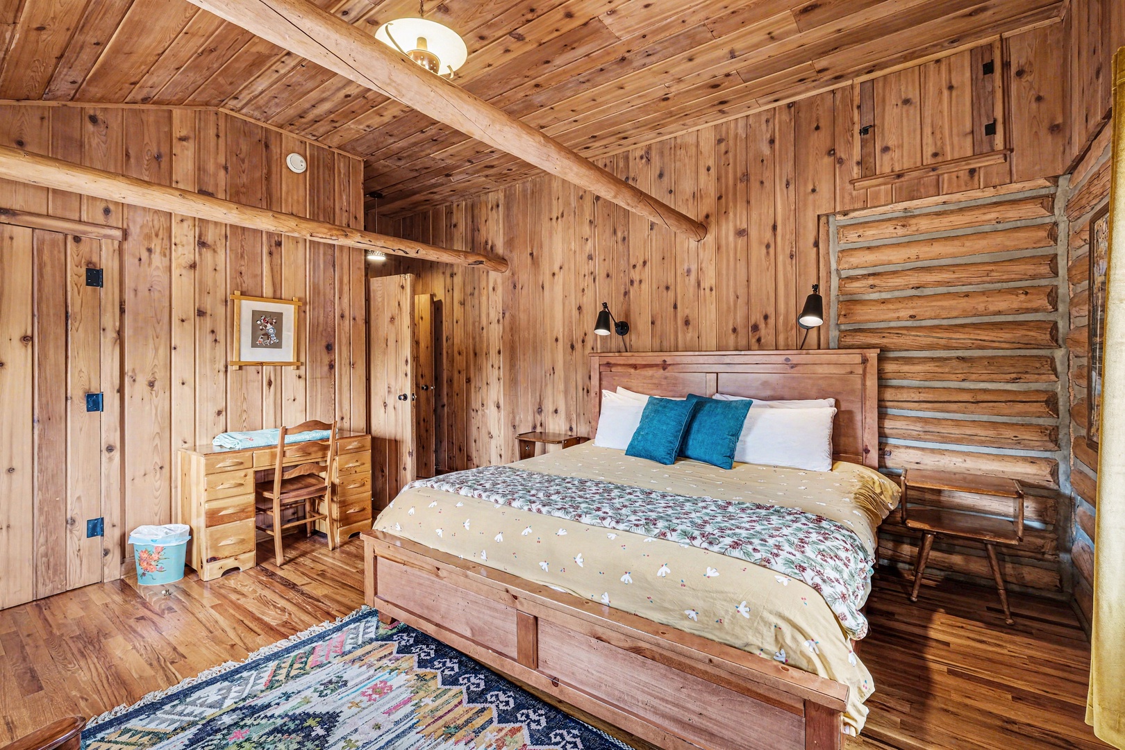 Drift off in this cozy wood-wrapped bedroom, where rustic charm meets comfort with soft linens and mountain cabin vibes.