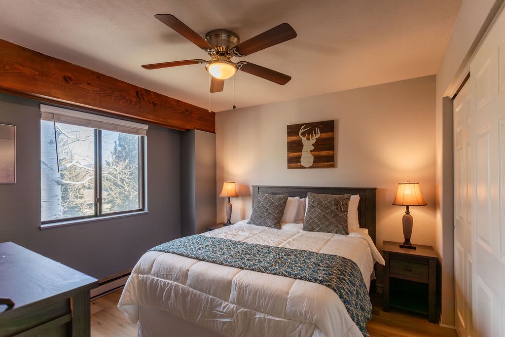 Drift off in this cozy bedroom where rustic charm meets modern comfort. Warm lamps create intimate ambiance for your peaceful retreat.