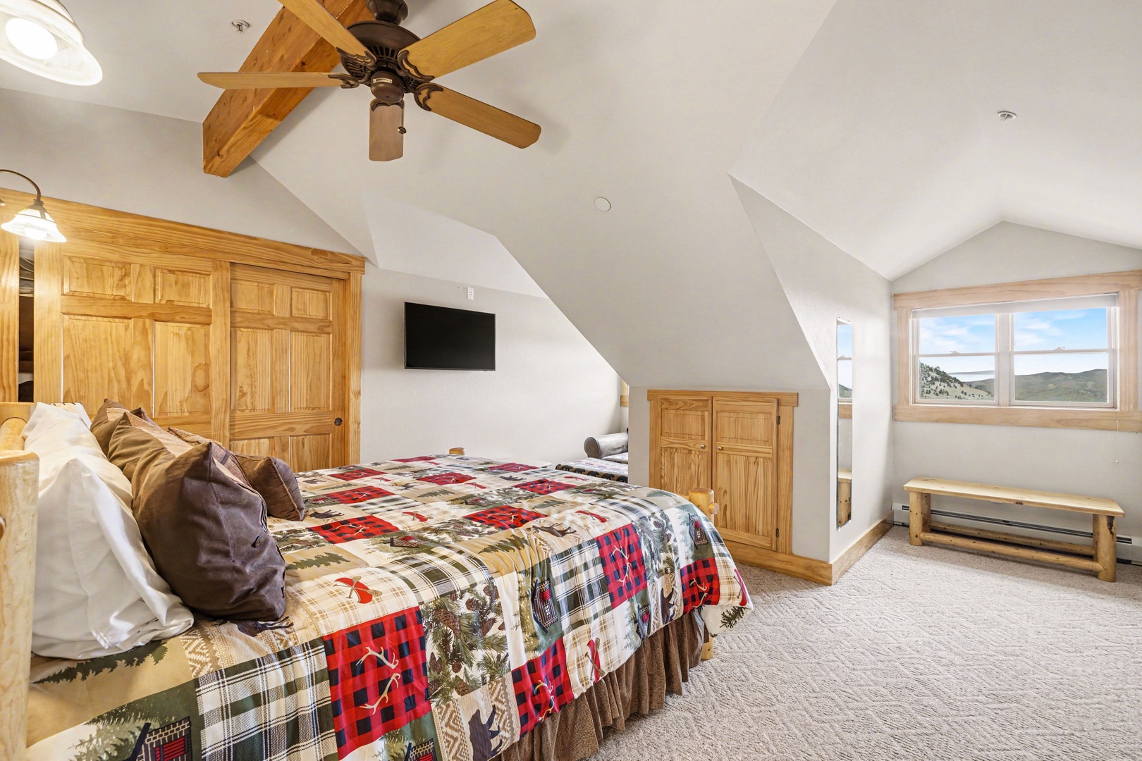 Drift off to peaceful sleep in your cozy retreat, where rustic charm meets comfort under soaring ceilings and gentle mountain views.