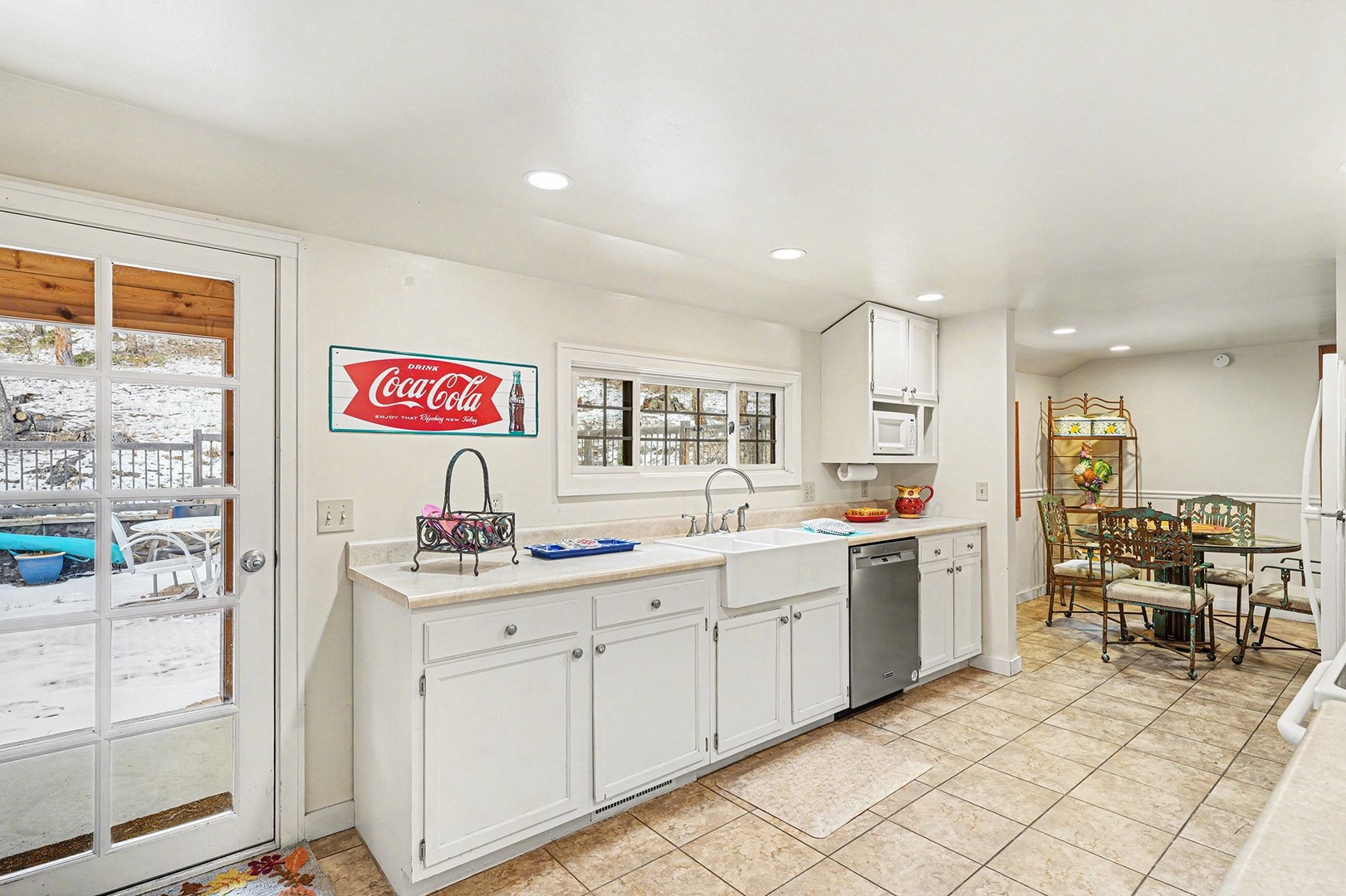 Cook your favorite meals in this bright kitchen with modern appliances and charming vintage touches, steps from your winter getaway.