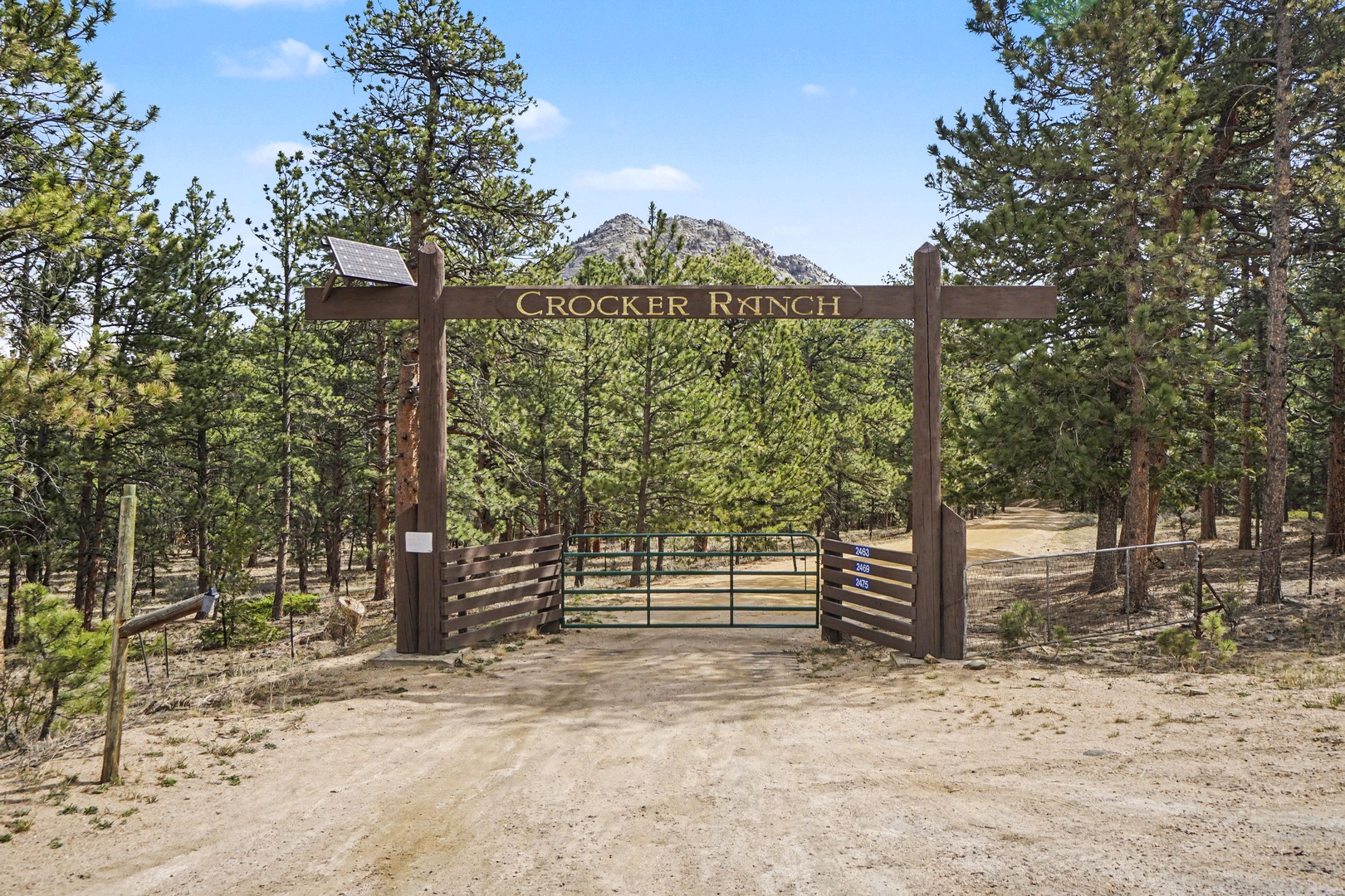 Welcome to Crocker Ranch, where dramatic mountain views and towering pines create a stunning backdrop for arrival.