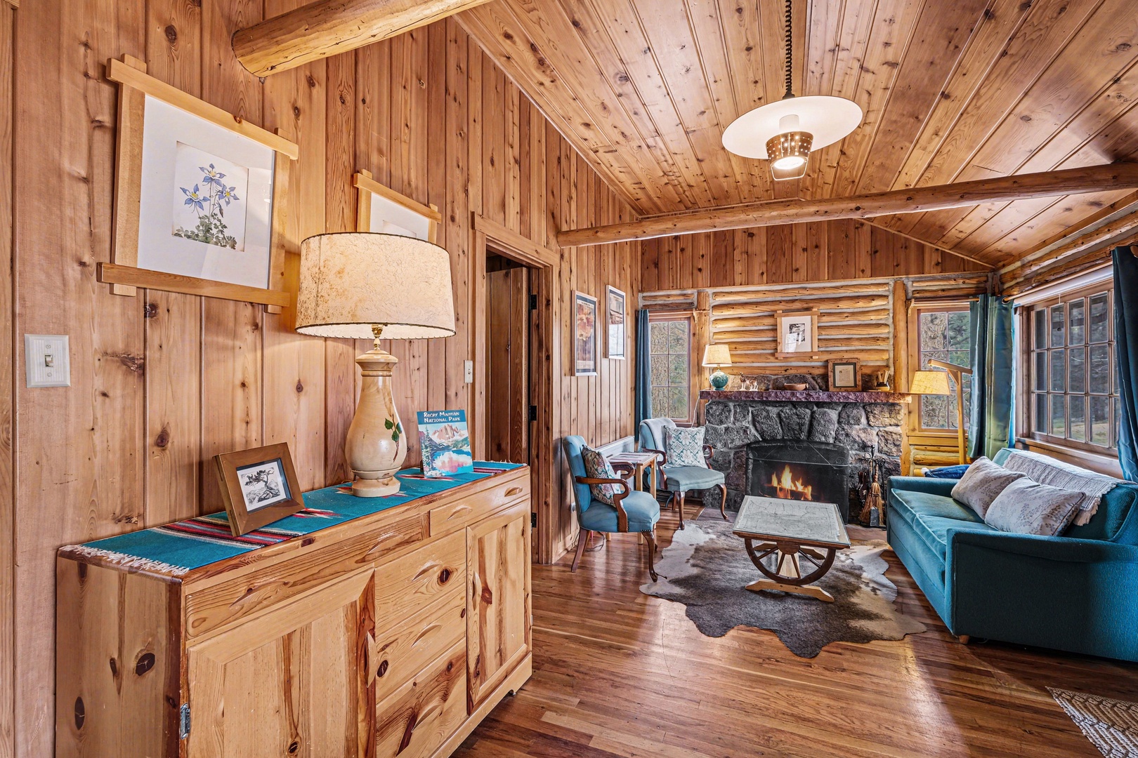 Curl up by your crackling fireplace in this cozy log cabin living room, where rustic charm meets modern comfort.