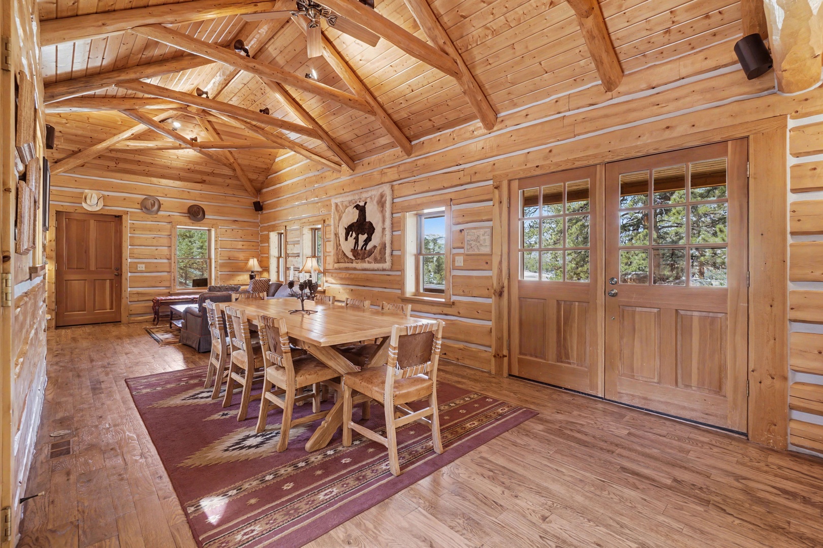 Gather around the rustic dining table in your cozy log cabin, where exposed beams and warm wood create the perfect atmosphere for memorable meals together.