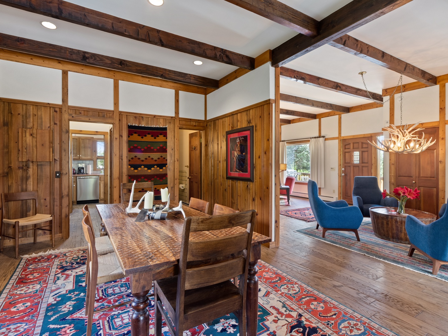 You'll love gathering around this rustic wood dining table beneath stunning exposed beams, with your cozy living area just steps away.