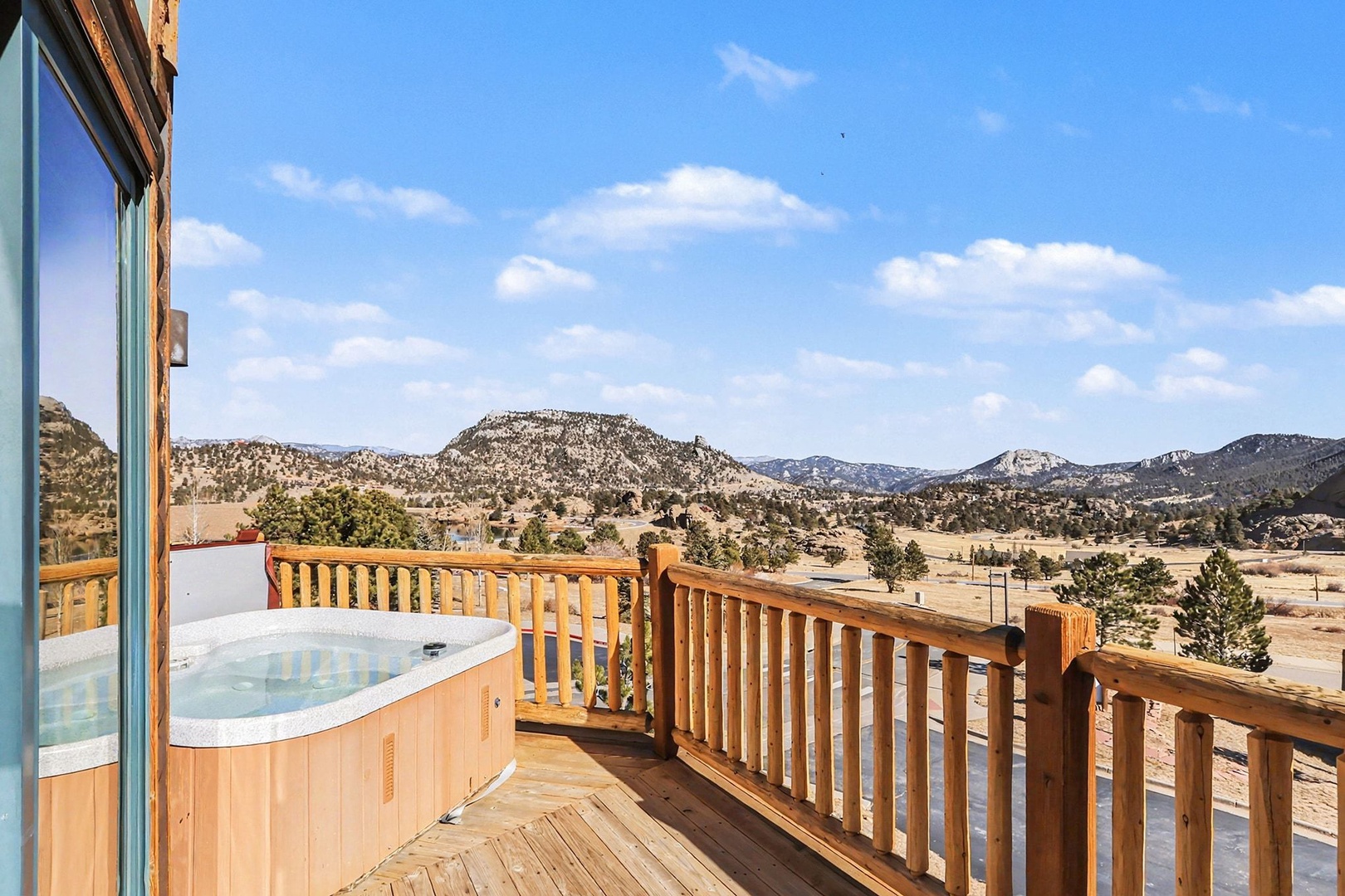 Soak in your private hot tub while gazing at sweeping mountain vistas from this elevated wooden deck.
