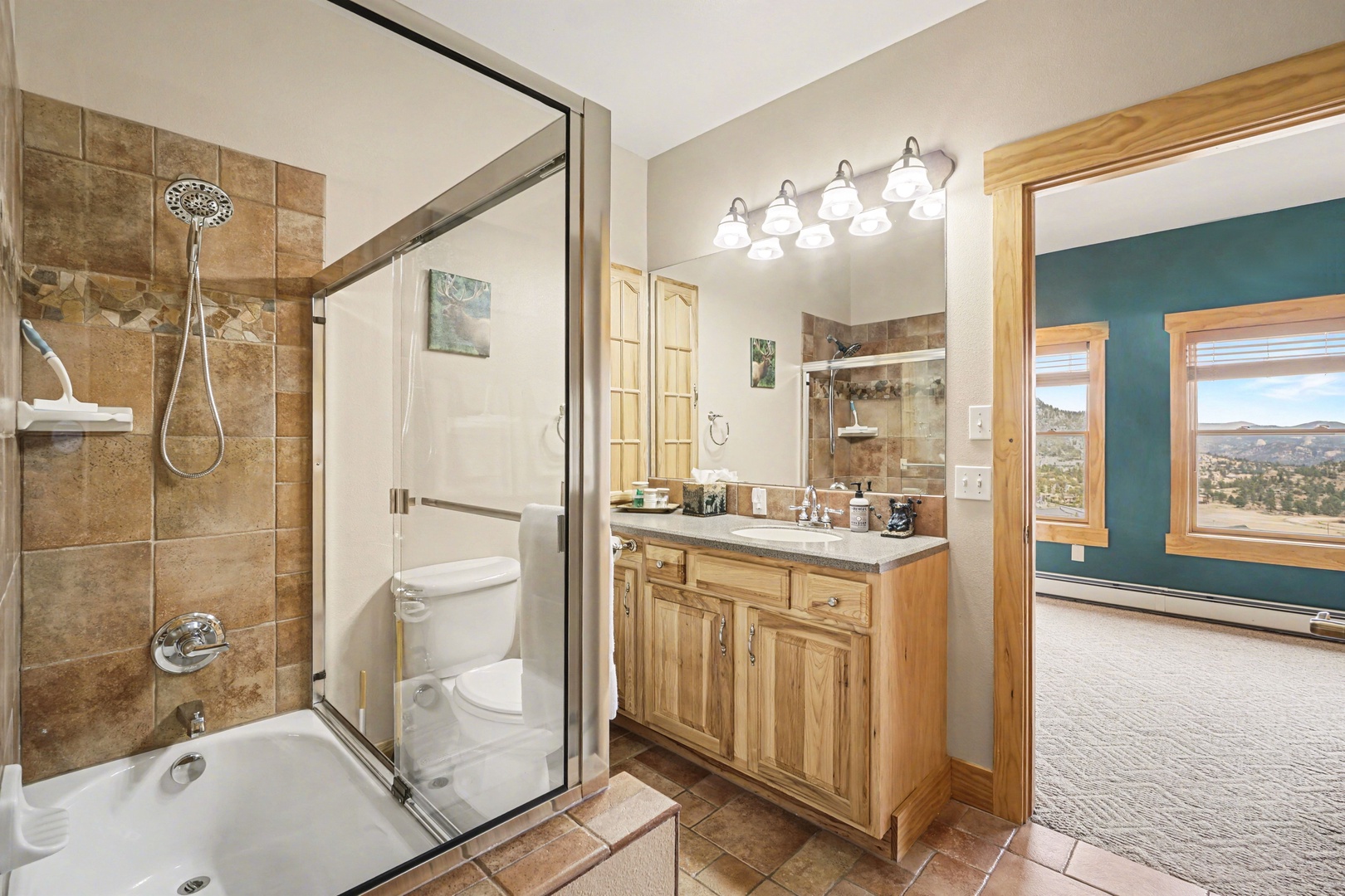 Step into your private bathroom featuring a tiled shower, soaking tub, and warm wood vanity.