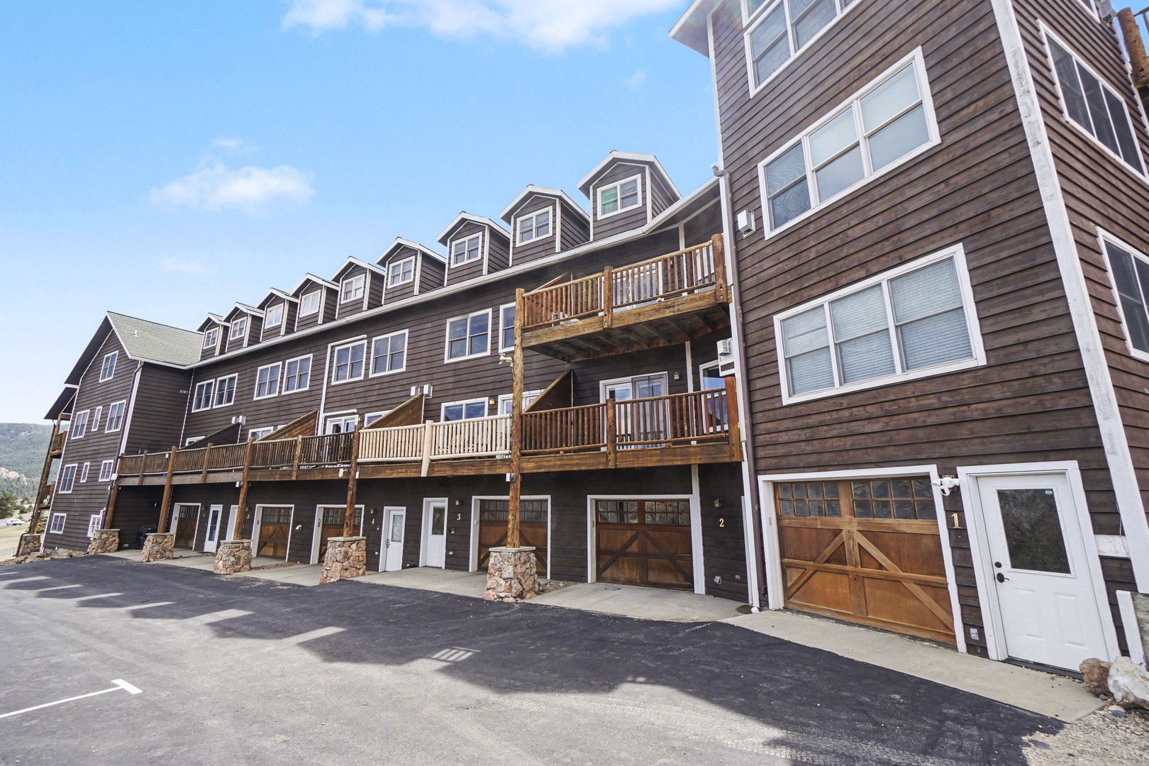 Modern townhouse with wooden balcony and mountain views, featuring your own garage.