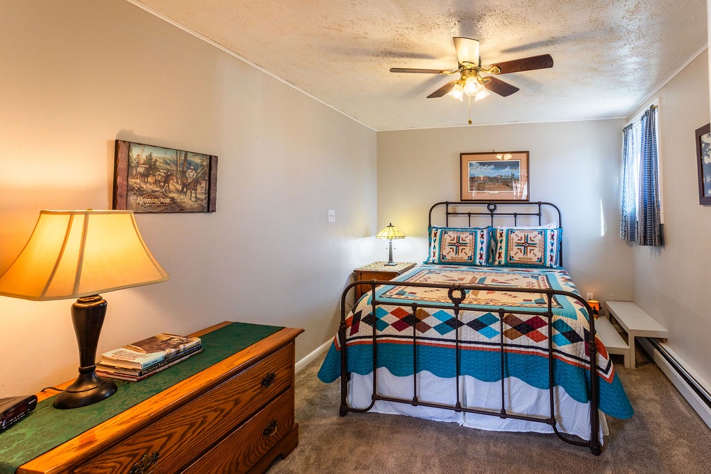 Unwind in your cozy bedroom with warm lighting and colorful Western-style bedding that creates the perfect retreat after exploring.