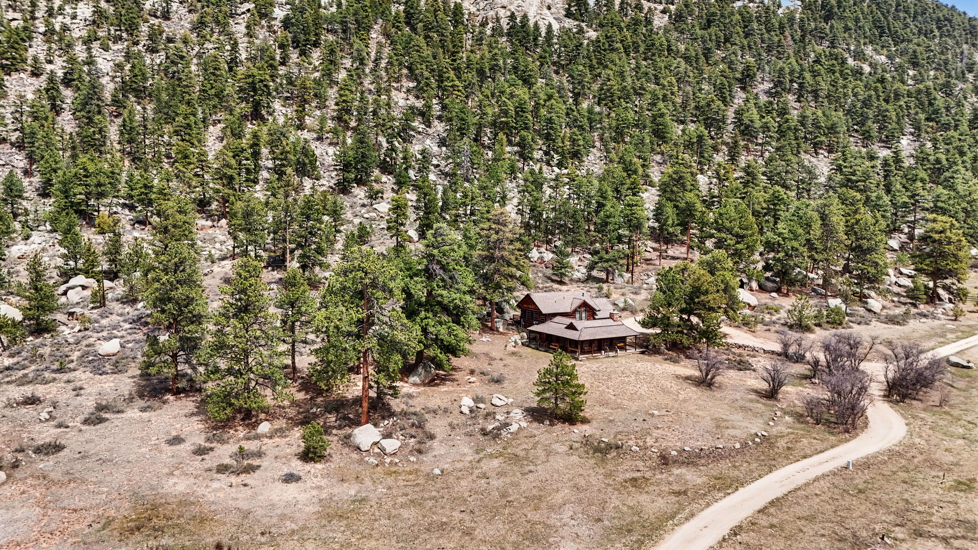 Secluded mountain retreat nestled among towering pines and granite formations, offering complete privacy in nature's embrace.