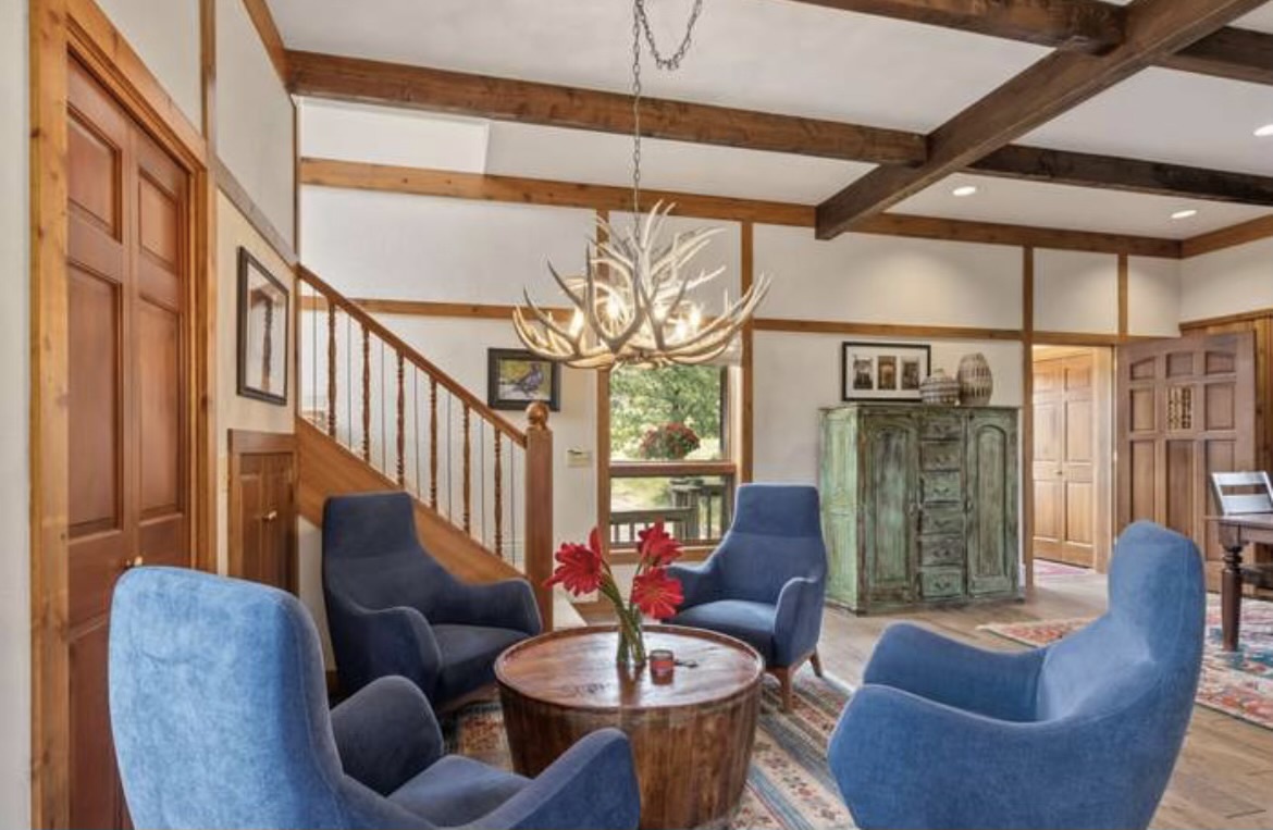 Relax in the living room with beautiful antler chandelier. Enjoy the comfy seating around a cozy conversation circle.