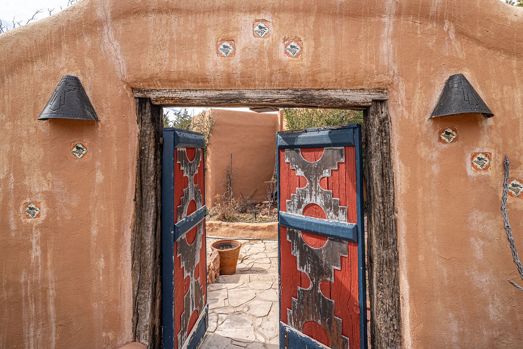 Adobe-style entrance with colorful handcrafted doors leads to your unique southwestern retreat.