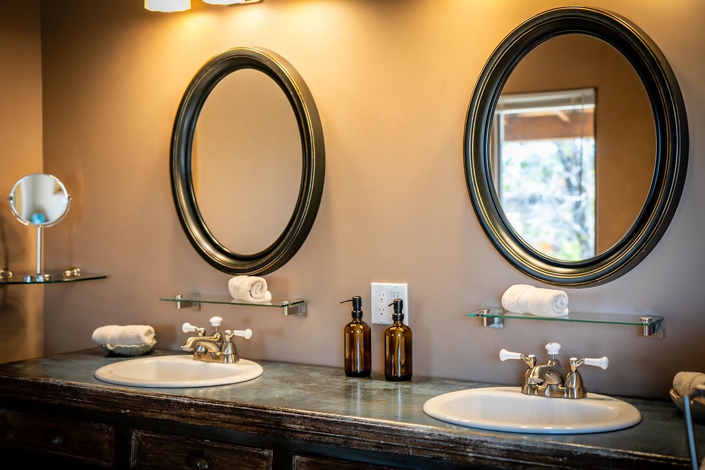 Double vanity with elegant mirrors creates your perfect morning routine space, complete with premium toiletries and plush towels.