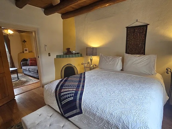 Unwind in your serene retreat featuring a plush bed, kiva fireplace, and authentic Southwestern charm. The adjoining room offers extra space for your group.