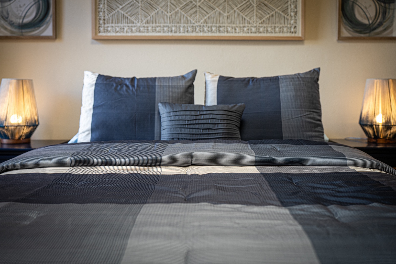 Sink into crisp, comfortable bedding with stylish geometric patterns and soft ambient lighting for your perfect night's rest.