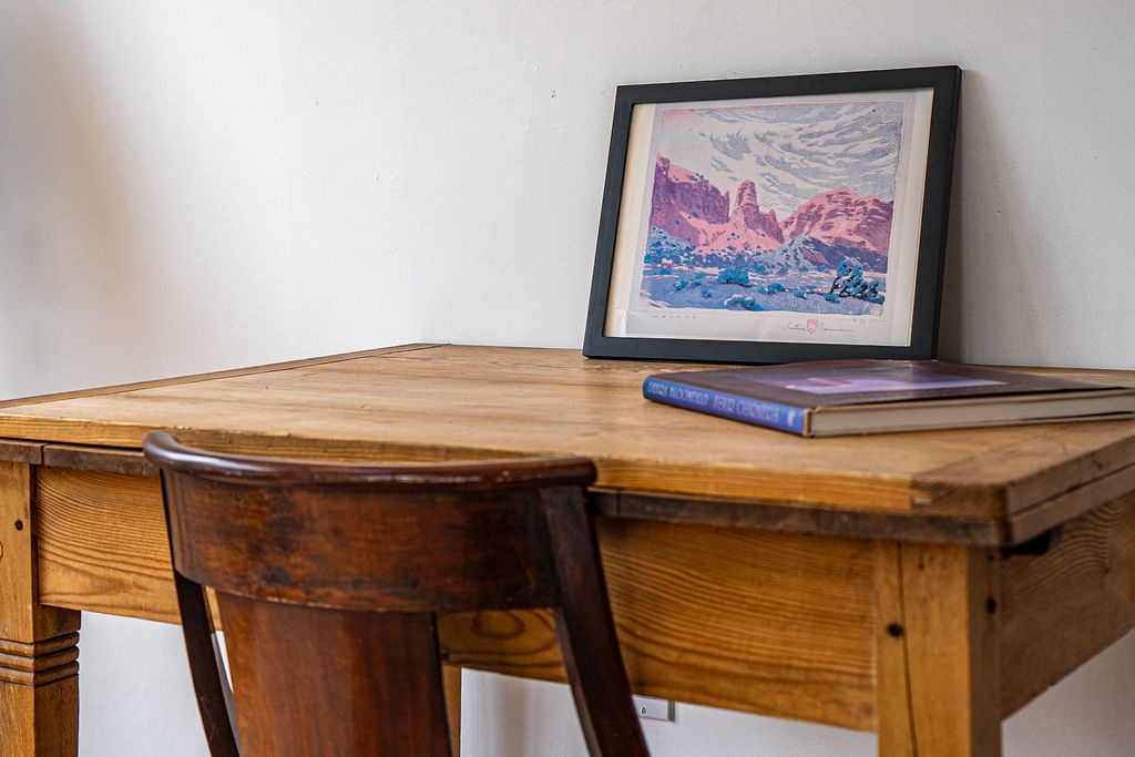 Your workspace awaits with warm wood character and thoughtful touches—perfect for catching up on reading or planning tomorrow's adventures.