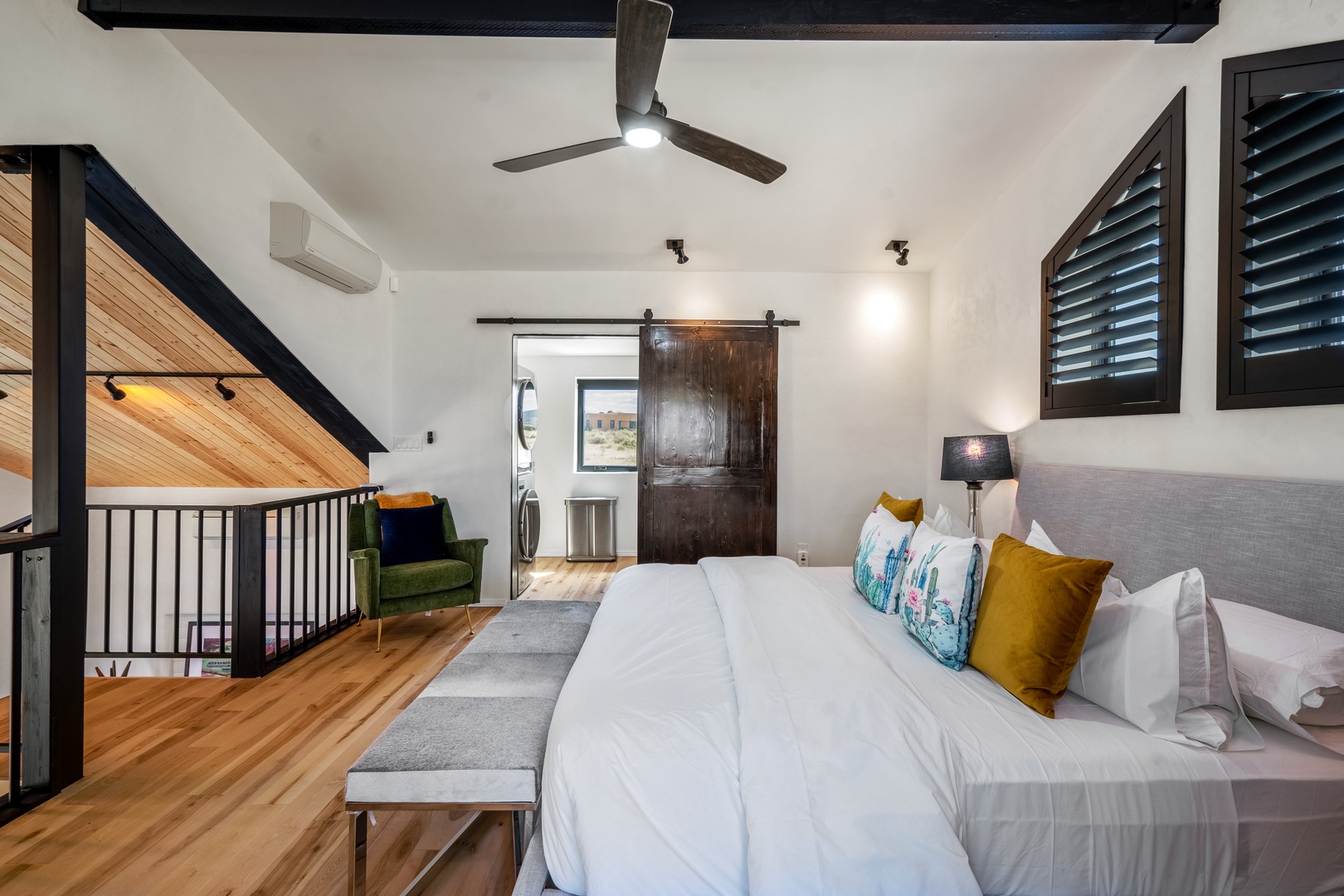 Your stylish loft bedroom features soaring ceilings, warm wood accents, and modern comfort with a ceiling fan keeping you cool.