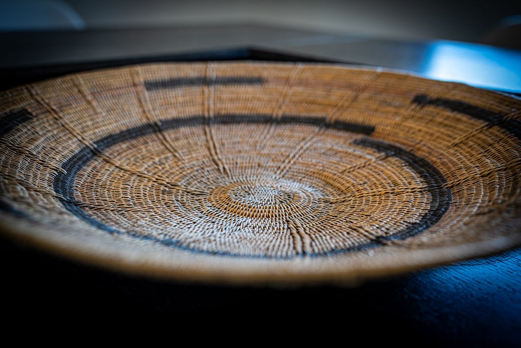 Admire the intricate craftsmanship of this handwoven basket, showcasing beautiful traditional patterns that add authentic cultural charm to your stay.