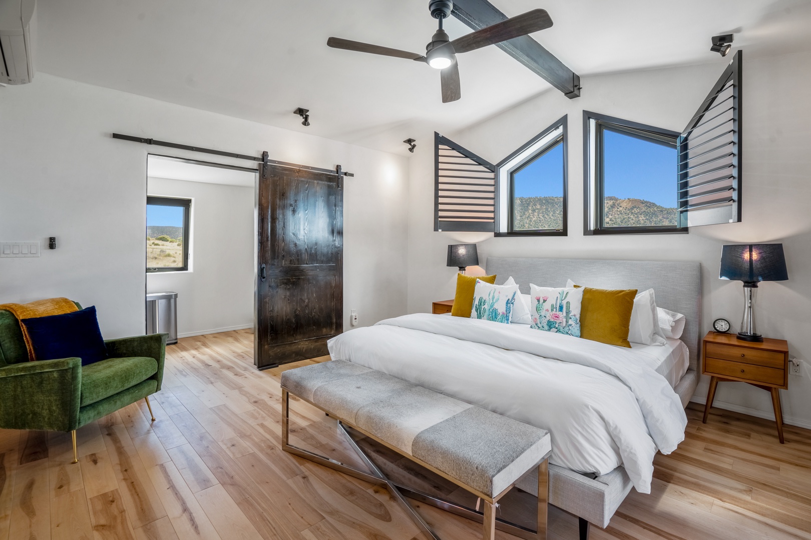 Unwind in your modern retreat with mountain views, rustic sliding door, and plush bedding for the perfect escape.
