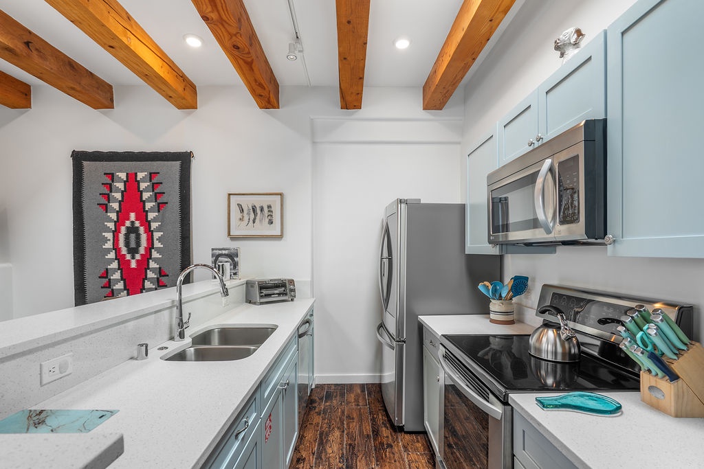 Your modern kitchen features exposed wooden beams, stainless steel appliances, and everything you need to create memorable meals during your stay.