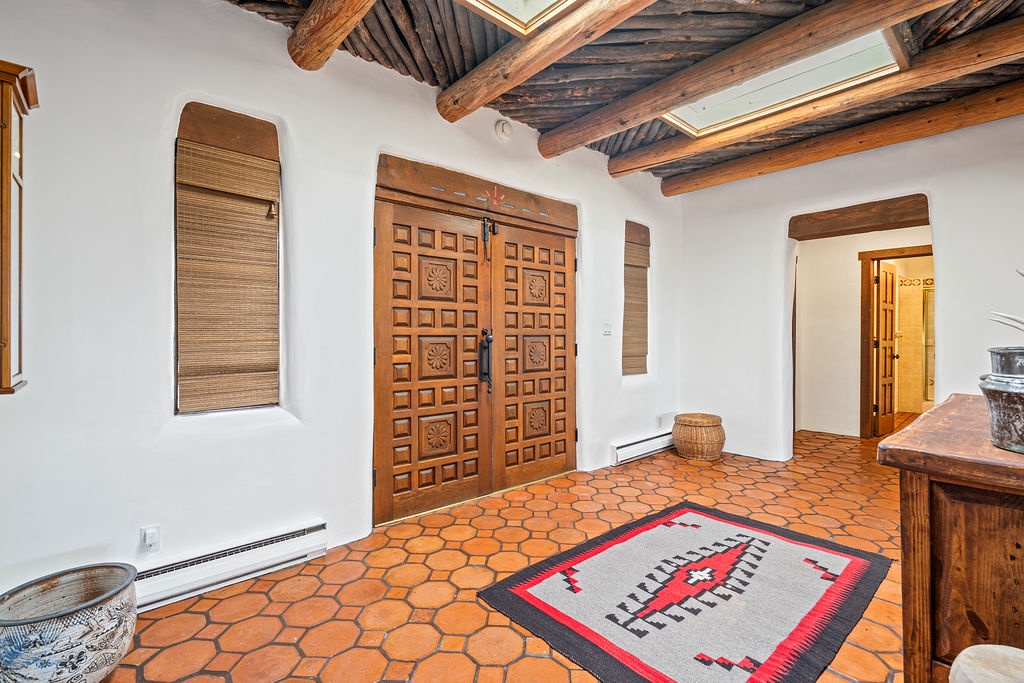 Step into authentic charm with hand-carved wooden doors, rustic exposed beams, and beautiful terracotta tiles that welcome you home.