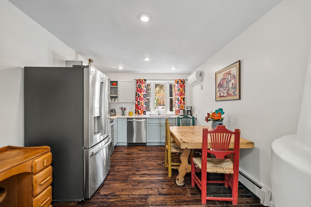 Gather around your charming farmhouse table in this fully equipped kitchen, where colorful accents and modern appliances create the perfect space for cooking memorable meals together.
