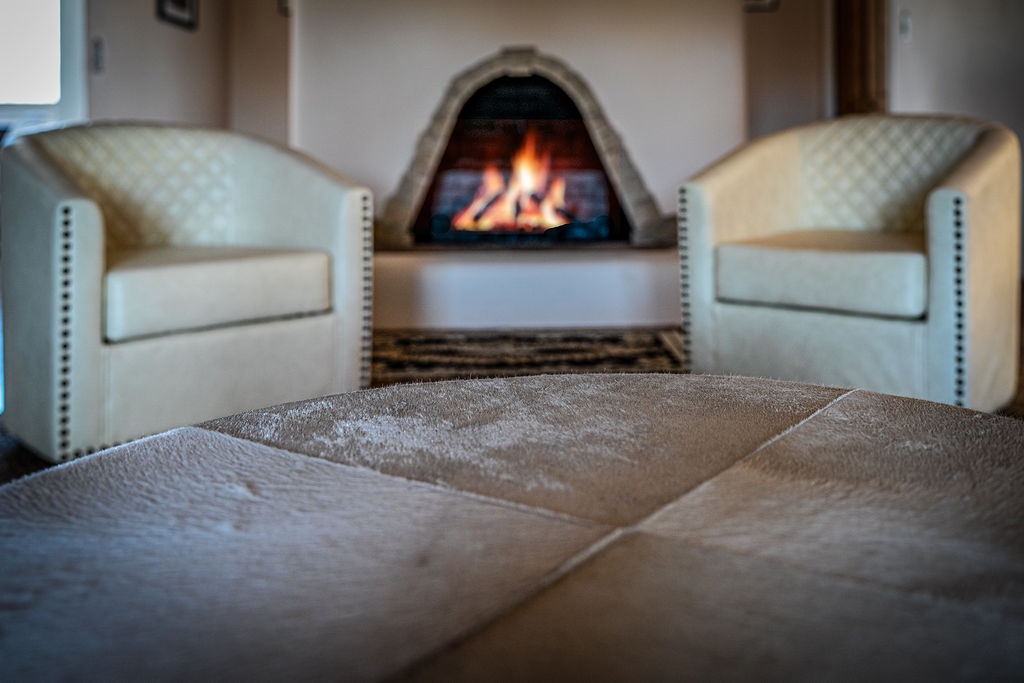 Curl up by your crackling fireplace in plush leather seating—the perfect spot to unwind with evening warmth dancing across your toes.
