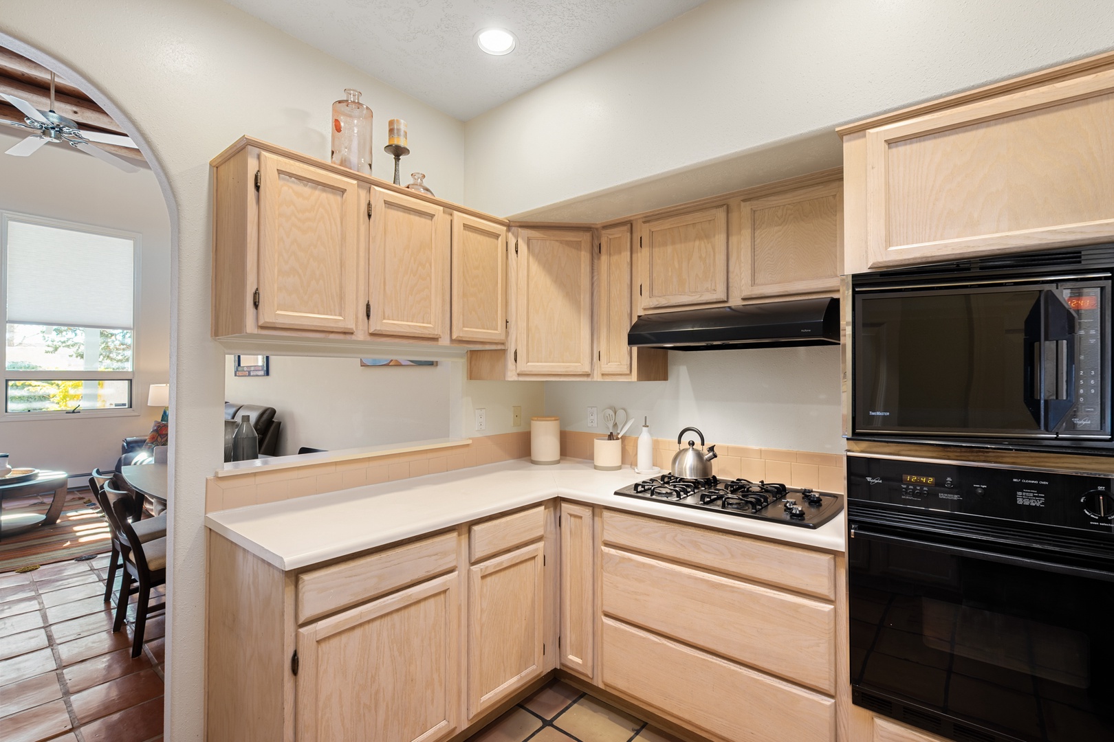 Your fully equipped kitchen features light wood cabinetry, gas stovetop, and all the essentials for preparing meals during your stay.