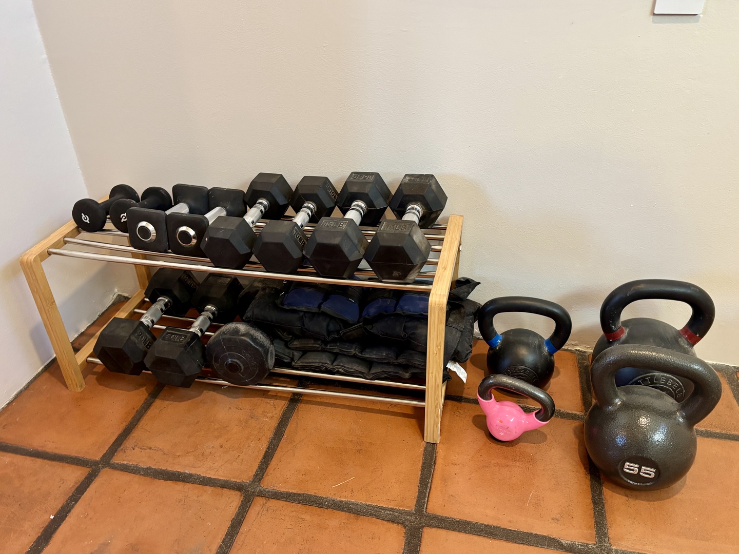 Stay strong on vacation with your private fitness setup featuring dumbbells, kettlebells, and resistance bands for energizing workouts.