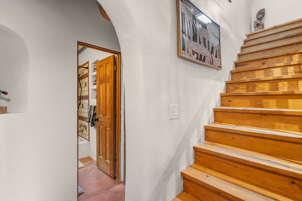 Beautiful wooden stairs lead you to your upstairs retreat, while authentic art adds character to this welcoming space.