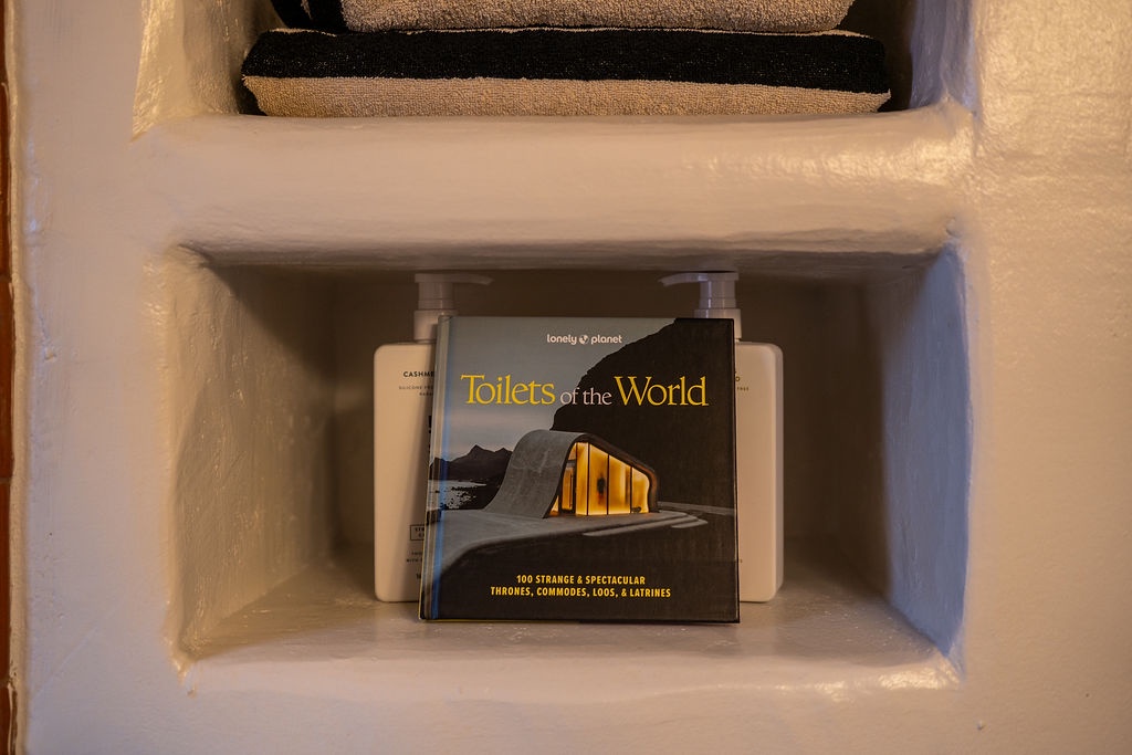 Your bathroom features thoughtful touches like fresh towels and quirky reading material to keep you entertained during downtime.