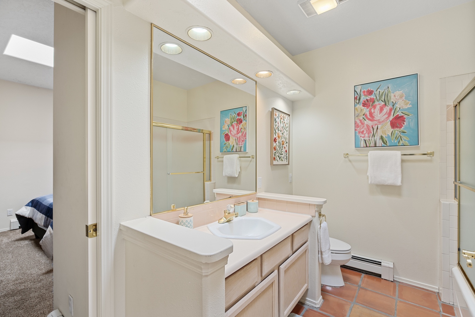 Your private bathroom features elegant vanity lighting, fresh towels, and thoughtful amenities to start your day refreshed.