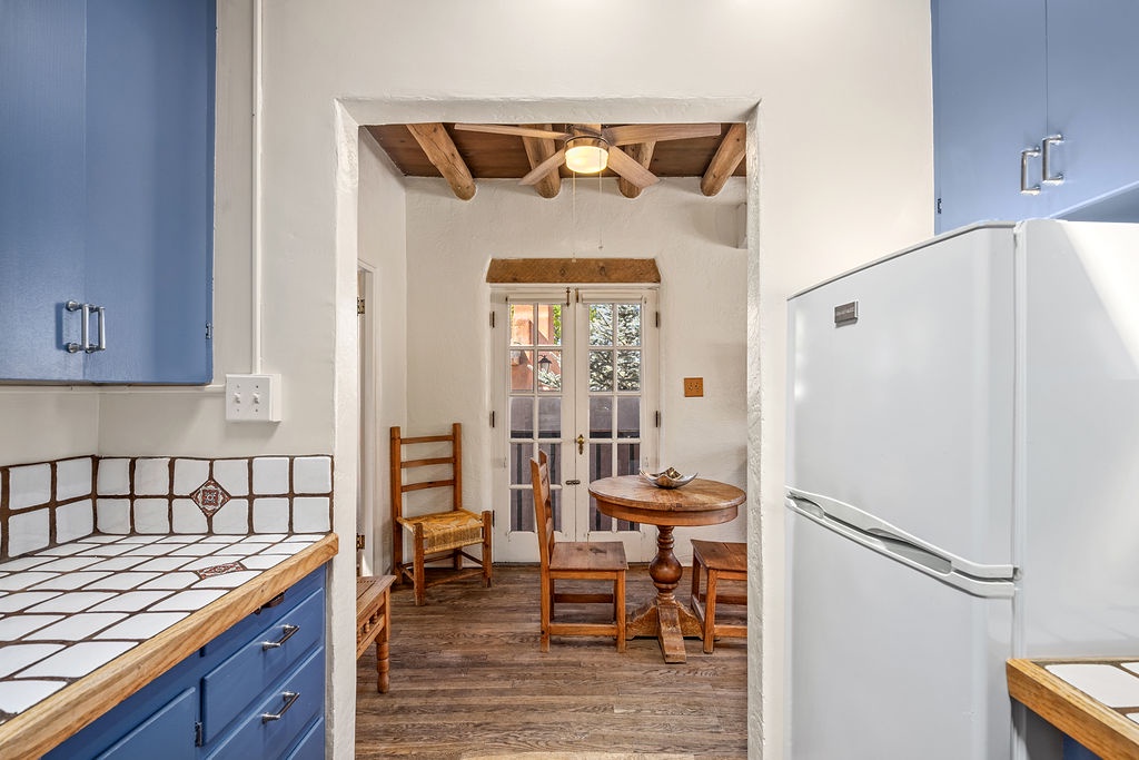 Step into your charming kitchen with rustic wood beams overhead and a cozy dining nook where you'll savor morning coffee by French doors.