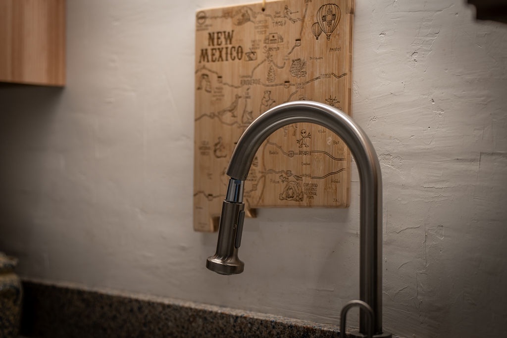 Your modern pullout faucet makes meal prep effortless, while the charming New Mexico map adds local character to your cooking space.