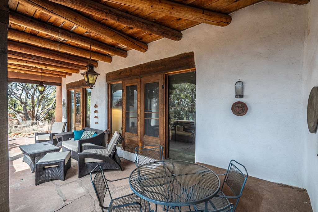 Relax on your private covered terrace with rustic wooden beams overhead and comfortable seating where you can dine al fresco.
