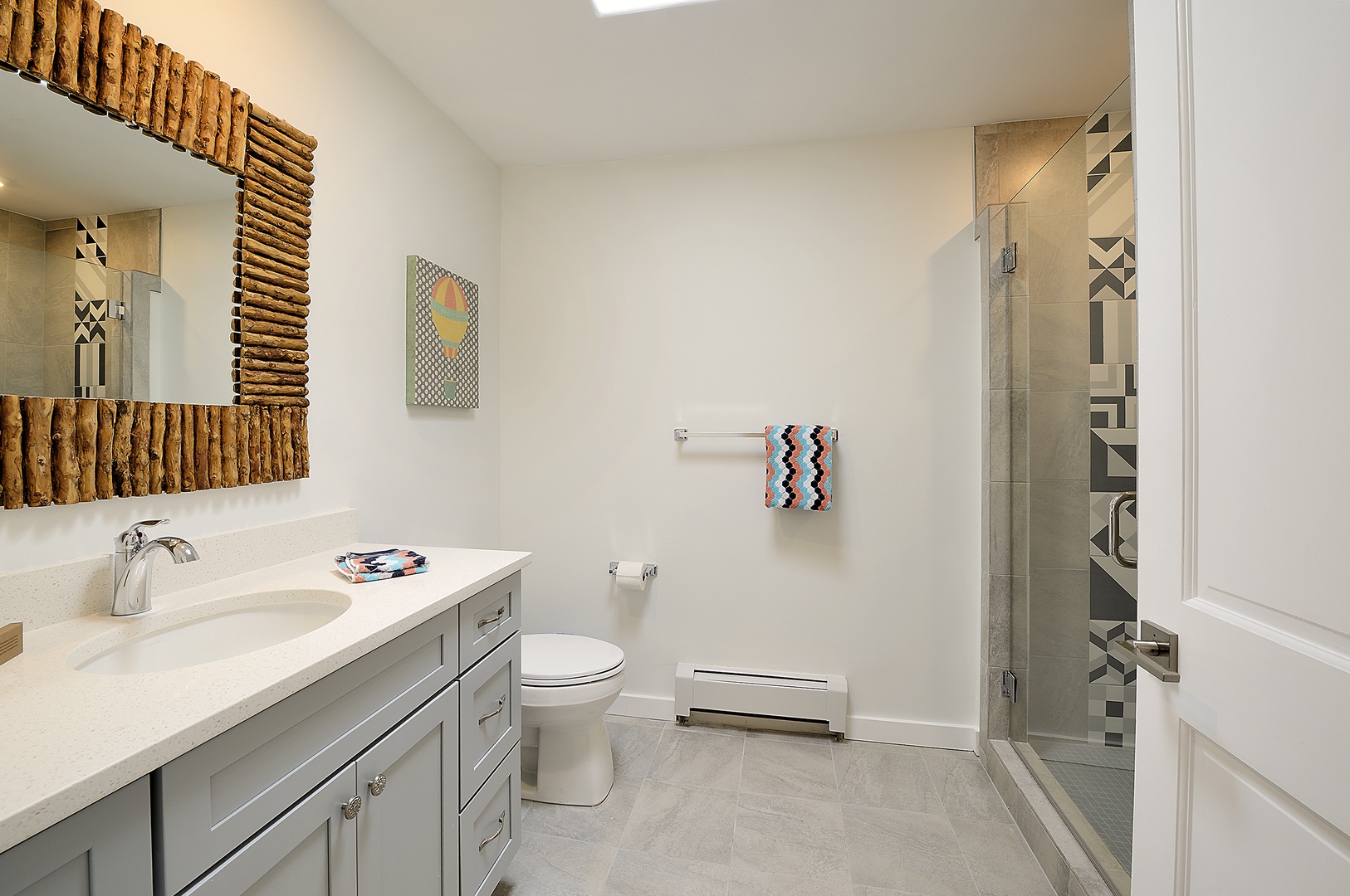 Your spacious bathroom features elegant vanity and walk-in shower.