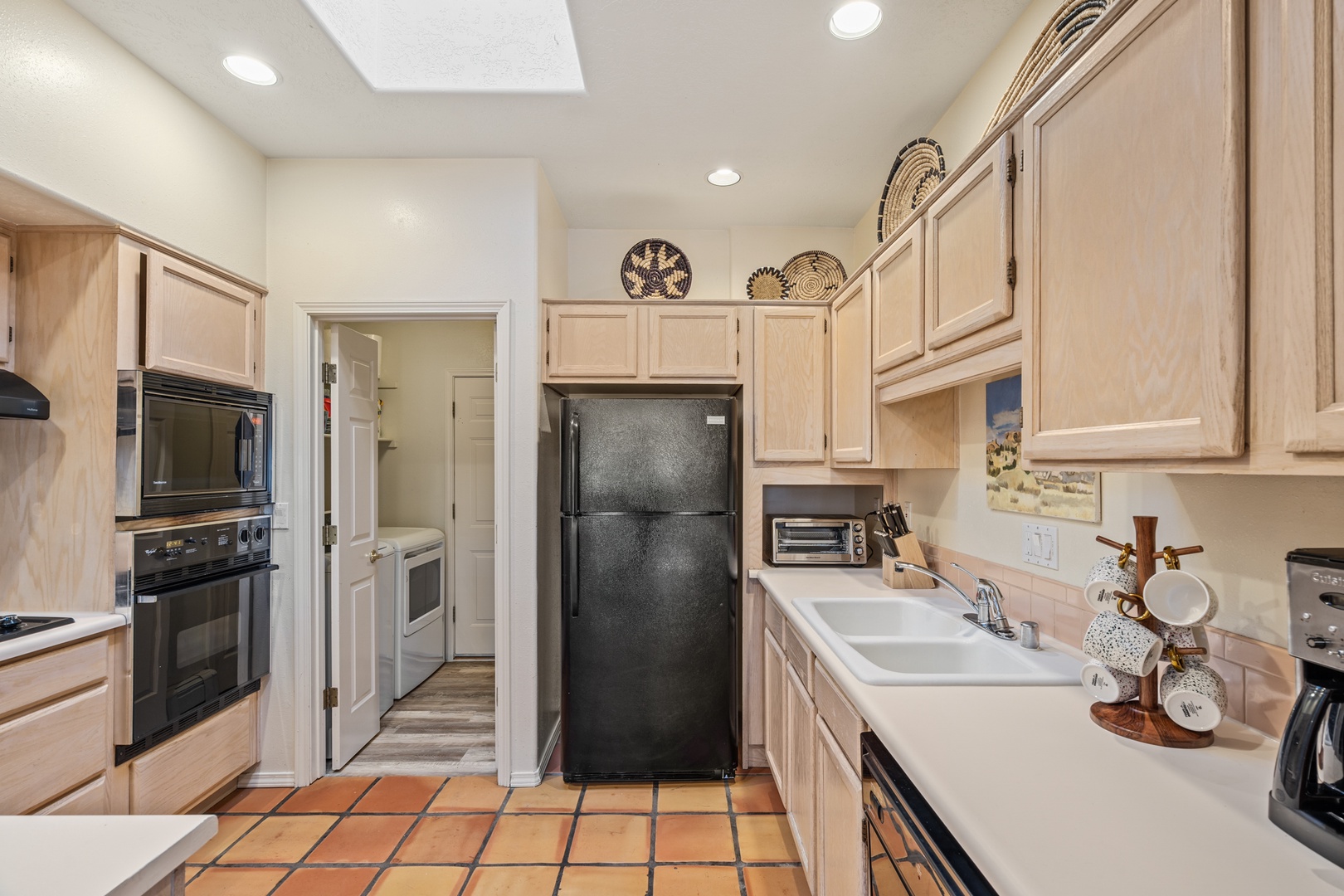 Your fully equipped kitchen features warm wood cabinetry, modern appliances, and everything you need to prepare meals during your stay.