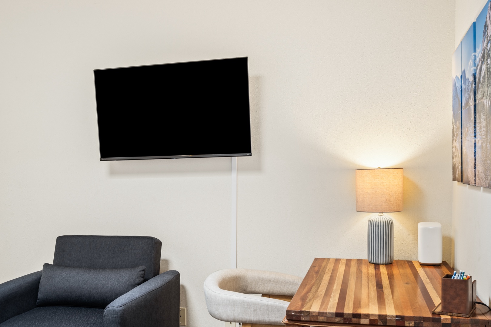Relax in your modern living area featuring a wall-mounted TV and stylish seating for cozy evenings in.