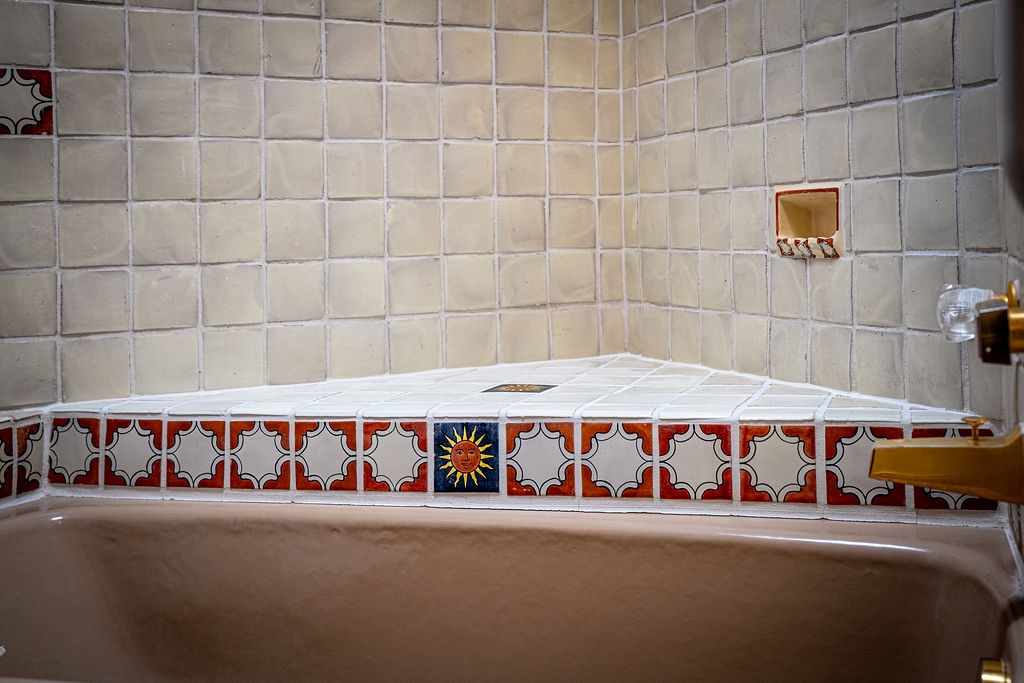 Unwind in your private bath featuring beautiful handcrafted tilework and decorative ceramic accents that create a uniquely charming atmosphere.