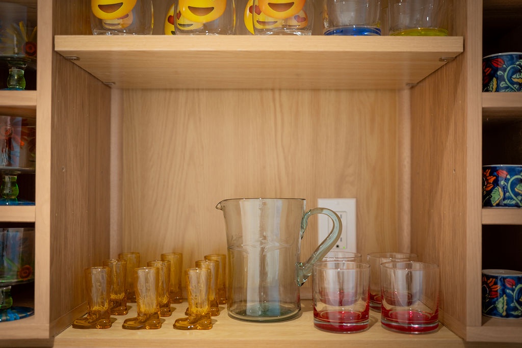 Your kitchen is fully stocked with colorful glassware and serving pieces, ready for memorable meals and drinks with loved ones.