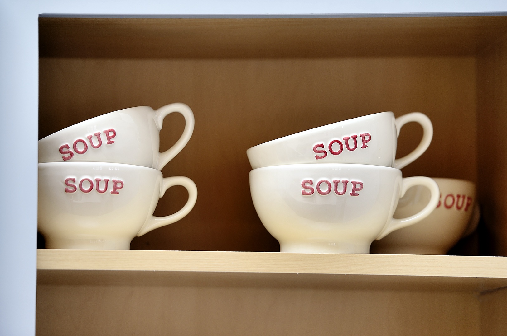 Charming soup bowls await your cozy kitchen moments, perfectly stacked and ready for warming comfort food during your stay.
